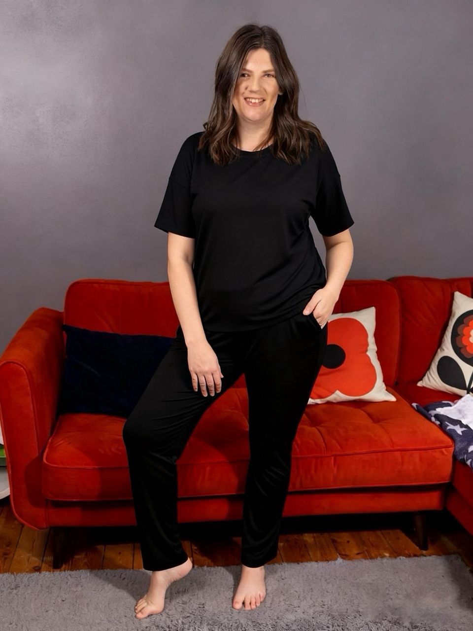 mum wearing her milkymoon breastfeeding pyjamas in black stood up with hand in pocket.