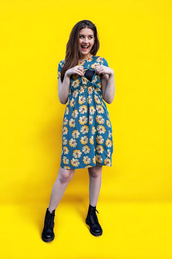 Mum showing breastfeeding access via zips on her sunflower breastfeeding dress from MilkyMoon. 