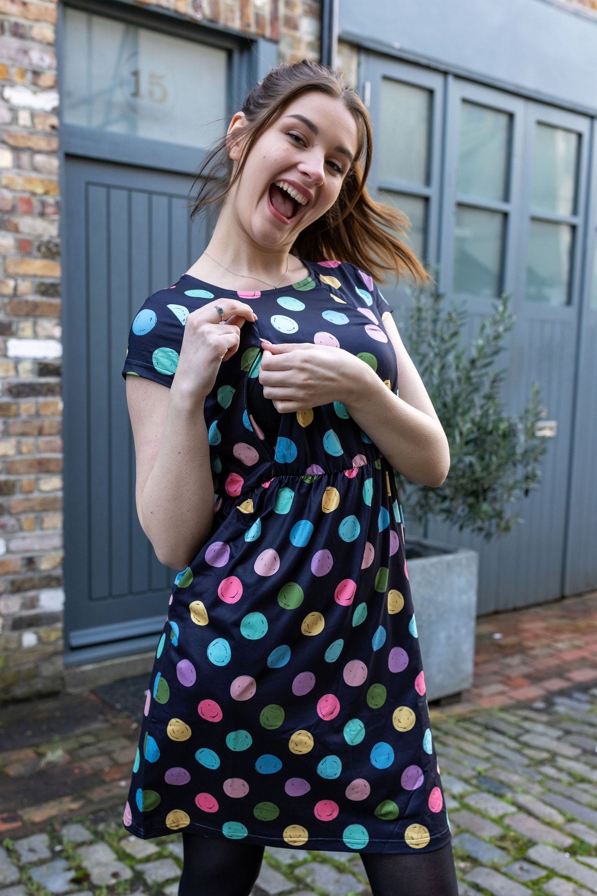 Mum showing the breastfeeding zip access on the Shona Spot Breastfeeding Dress - Stylish Mum